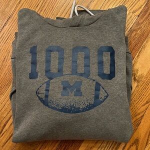MICHIGAN WOLVERINES FOOTBALL 1000
WINS ALL SEASON HOODIE (UNISEX)